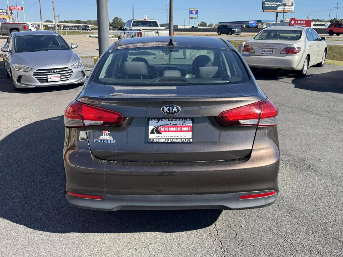 2017 Brown Kia Forte (3KPFL4A73HE) with an 4-Cyl, 2.0 Liter engine, Automatic, 6-Spd transmission, located at 8008 Warden Rd, Sherwood, AR, 72120, (501) 801-6100, 34.830078, -92.186684 - Photo#6